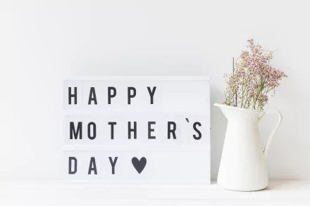 4K Ultra HD Mother's Day desktop wallpaper: minimalist lightbox reading 'HAPPY MOTHER'S DAY ♥' beside a white pitcher with delicate flowers on a clean holiday background.