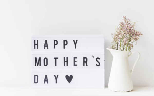 4K Ultra HD Mother's Day desktop wallpaper: minimalist lightbox reading 'HAPPY MOTHER'S DAY ♥' beside a white pitcher with delicate flowers on a clean holiday background.