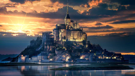 Mont Saint-Michel in France illuminated at sunset, showcasing its iconic religious architecture reflected in calm waters, presented in 4K Ultra HD resolution.