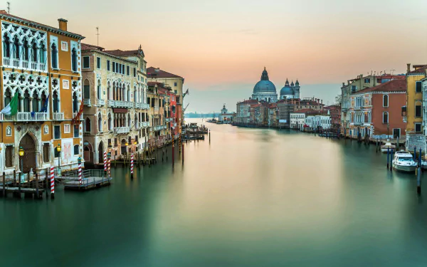 HD desktop wallpaper showcasing Venice’s Grand Canal with historic buildings and calm water under a soft sunset sky, highlighting iconic Italian architecture.