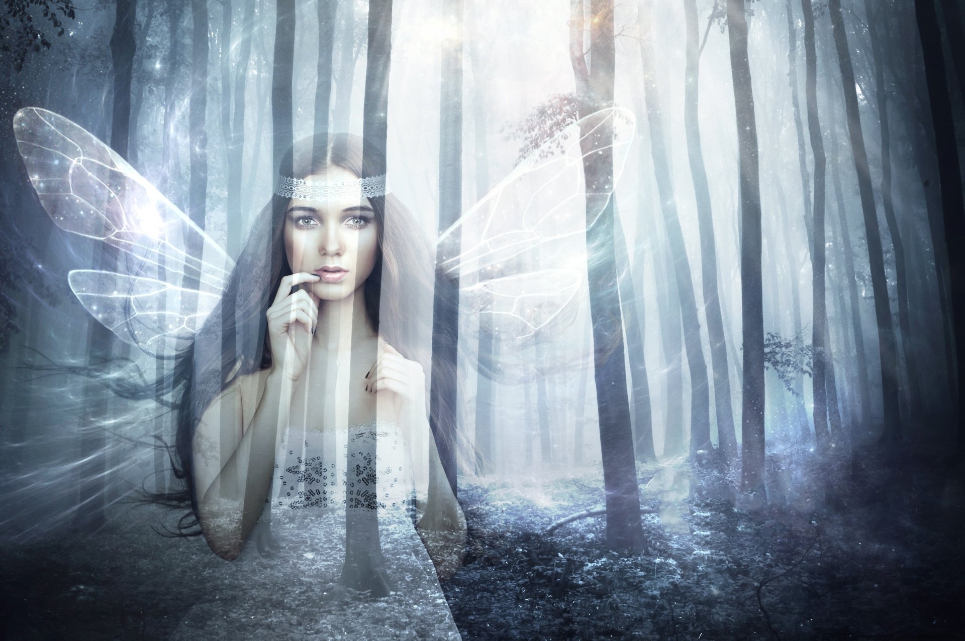 Ethereal fairy with translucent wings stands in a misty forest, bathed in soft light, creating a magical fantasy scene for an HD PC desktop wallpaper.