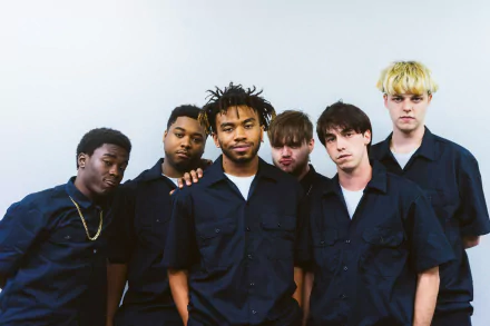HD desktop wallpaper featuring members of BrockHampton in blue shirts against a white background.