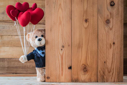 A teddy bear in a bow tie holding heart-shaped balloons against a wooden backdrop, suitable as a HD desktop wallpaper and background.