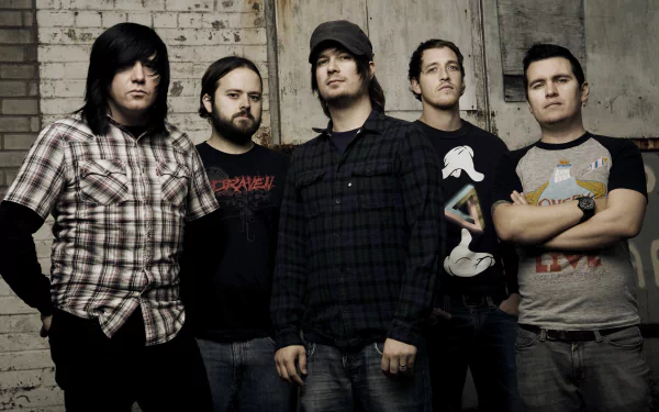 HD wallpaper featuring the band Funeral for a Friend standing together against a brick wall background.