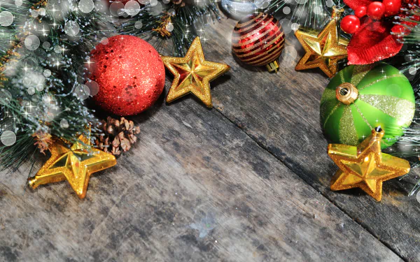 Christmas ornaments including baubles and golden stars arranged on rustic wood, captured as a vibrant 4K Ultra HD holiday desktop wallpaper background.