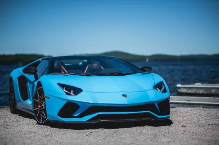 Bright blue Lamborghini Aventador S parked lakeside, low-angle view; 2K Quad HD PC desktop wallpaper/background.
