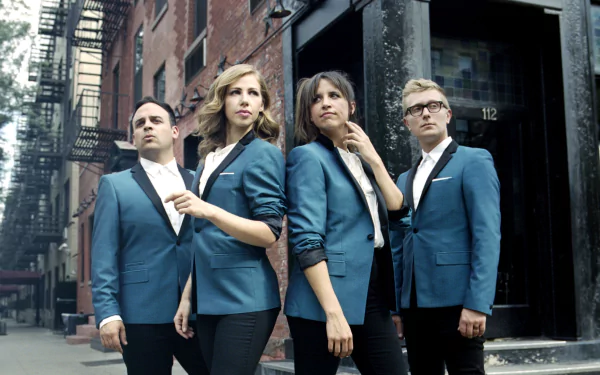 HD desktop wallpaper of Lake Street Dive band posing confidently in matching suits on an urban street.