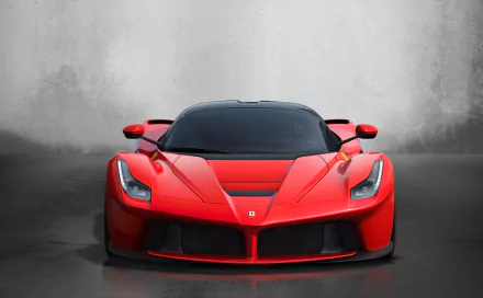 A sleek red Ferrari LaFerrari supercar showcased against a minimalist gray background in stunning 4K Ultra HD as a PC desktop wallpaper and background.