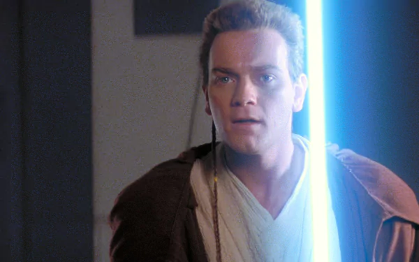 HD desktop wallpaper featuring Ewan McGregor as Obi-Wan Kenobi from Star Wars: Episode I - The Phantom Menace, holding a glowing blue lightsaber.