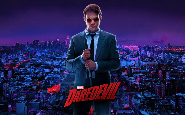 HD PC desktop wallpaper of Matt Murdock from the Daredevil TV show — in a suit and sunglasses, gripping his cane against a neon-lit city skyline.