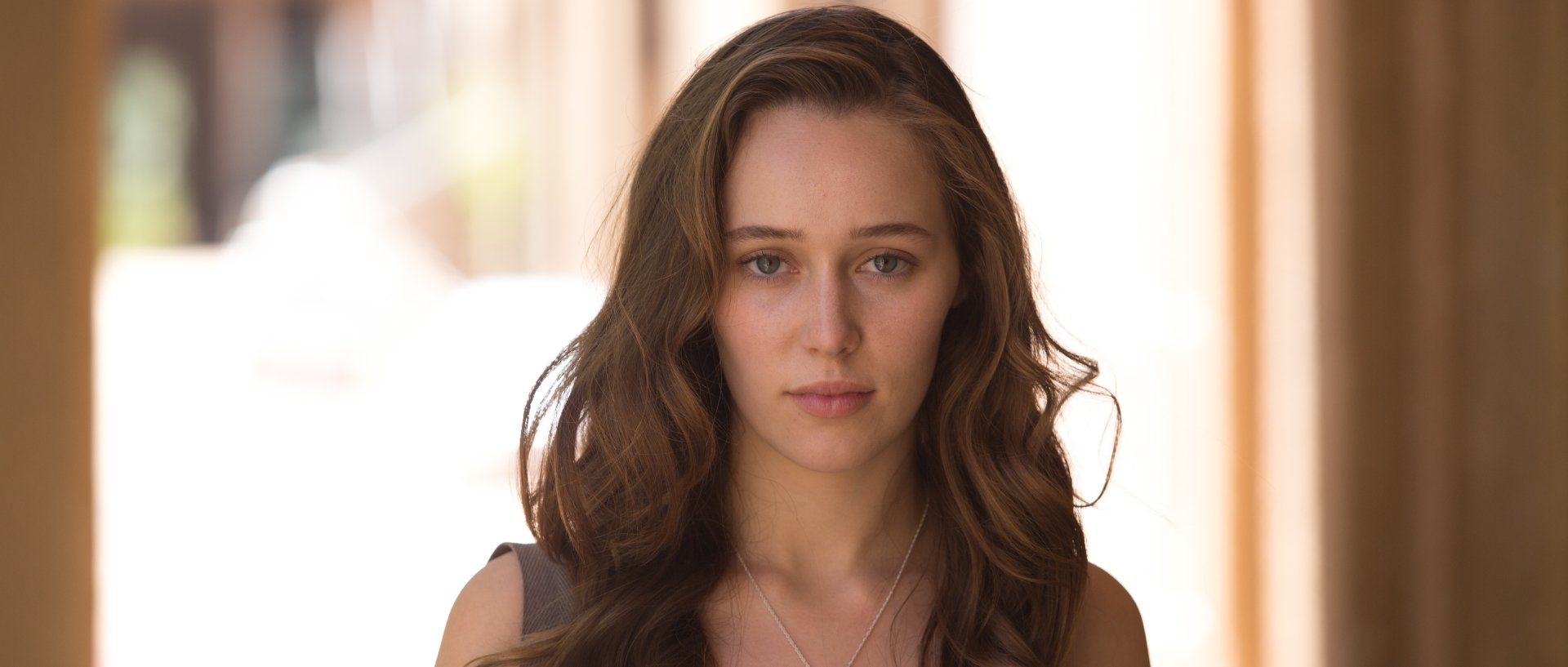 Close-up 4K Ultra HD desktop wallpaper of a young woman with long brown hair and a neutral expression, presented as a TV show promo for Fear the Walking Dead.