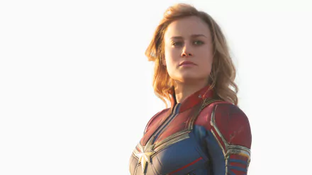 HD wallpaper of Brie Larson as Captain Marvel, showcasing the character's iconic costume and determined expression against a light background.