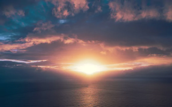 4K Ultra HD desktop wallpaper showcasing a vibrant sunset over a calm ocean horizon with dramatic clouds illuminated by warm sunlight.