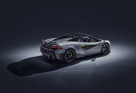 Silver McLaren 600LT supercar showcased in 4K Ultra HD, highlighting its sleek design and dynamic contours against a dark background.