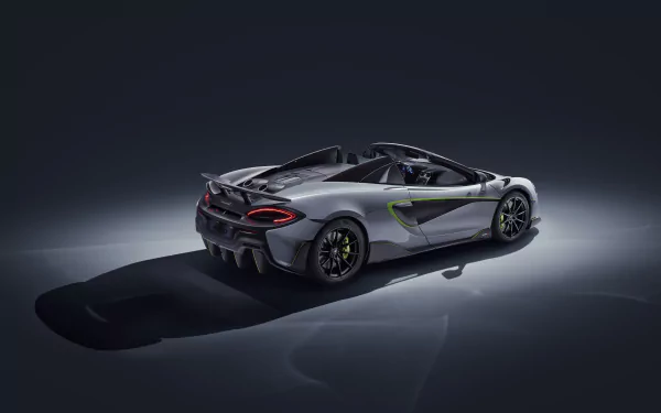 Silver McLaren 600LT supercar showcased in 4K Ultra HD, highlighting its sleek design and dynamic contours against a dark background.