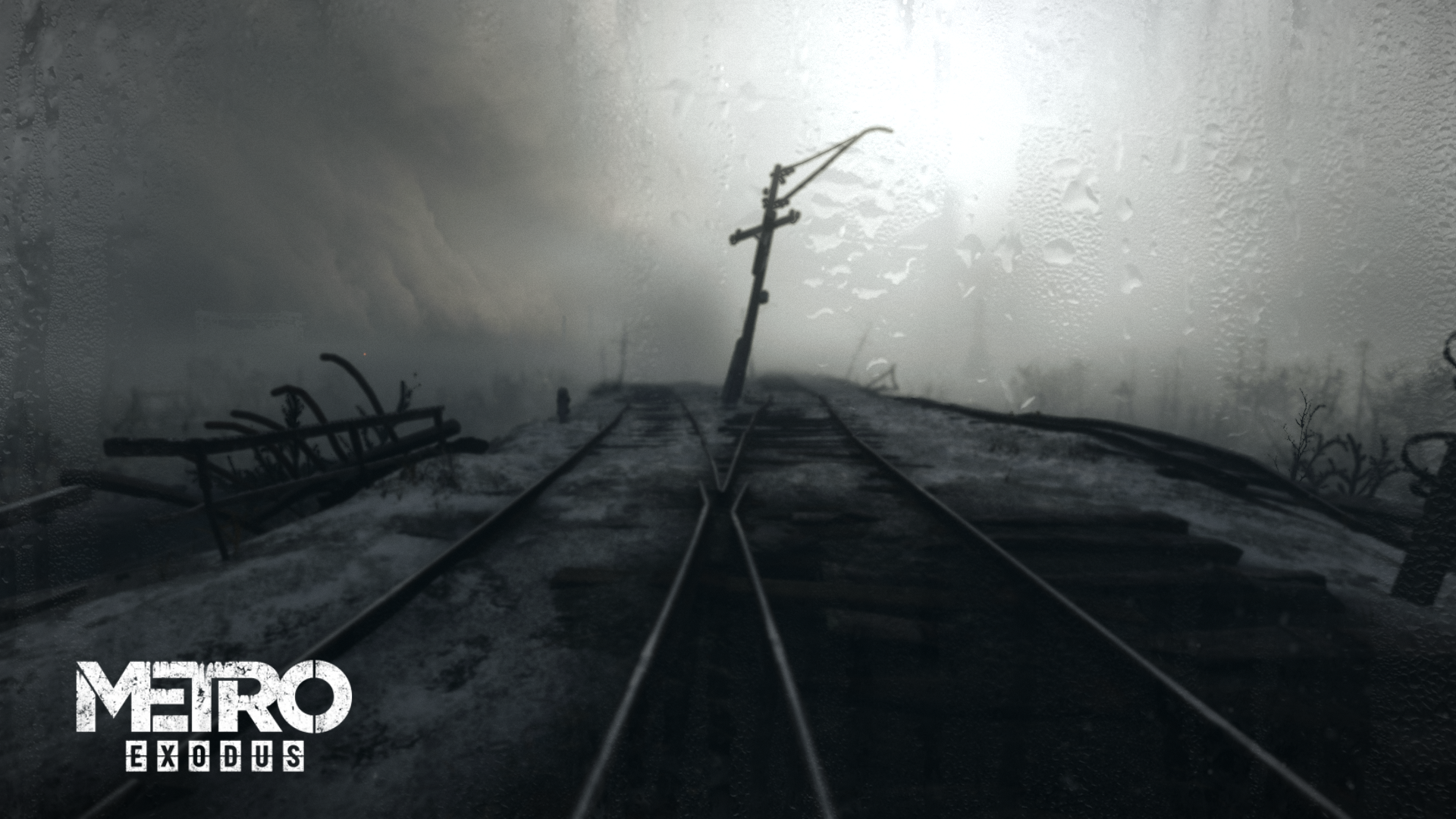 Apocalyptic scene from the video game Metro Exodus showing foggy, rain-soaked train tracks stretching into a bleak, desolate landscape in an HD PC desktop wallpaper.