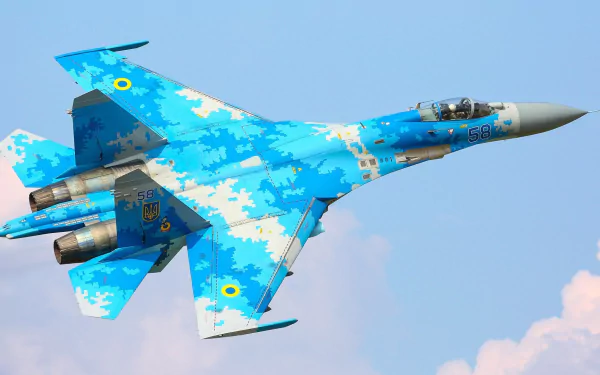 HD desktop wallpaper featuring a Ukrainian Air Force Sukhoi Su-27 jet fighter in blue digital camouflage soaring against a clear sky.